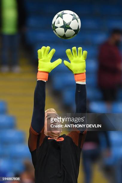 Manchester City's English goalkeeper Joe Hart warms up ahead of the UEFA Champions League second leg play-off football match between Manchester City...