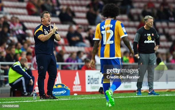 Micky Mellon, Manager of Shrewsbury Town gives instructions with David Moyes, Manager of Sunderland during the EFL Cup second round match between...