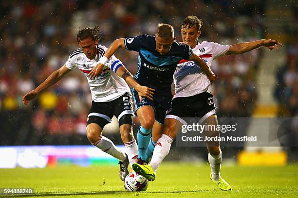 Viktor Fischer of Middlesbrough takes on Richard Stearman and Vigen Christensen of Fulham during the EFL Cup second round match between Fulham and...