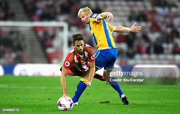 Adnan Januzaj of Sunderland is fouled by Ryan McGivern of Shrewsbury Town during the EFL Cup second round match between Sunderland and Shrewsbury...