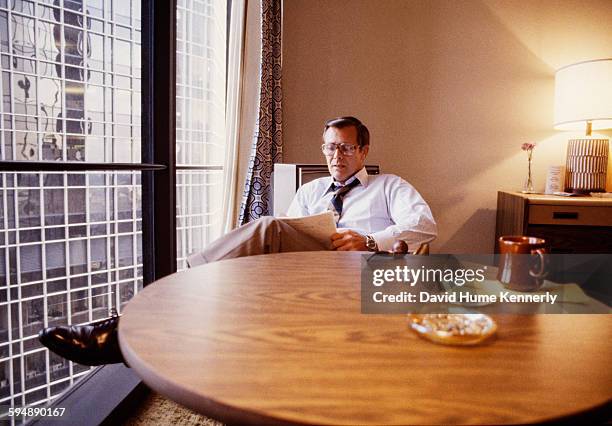 Former Secretary of Defense Donald Rumsfeld reads in his hotel room during the 1980 Republican National Convention, July 1980 in Detroit, Michigan. .