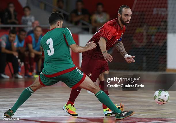 Portugal's Ricardinho with Morocco's Mohamed Jouad in action during the Futsal International Friendly match between Portugal and Morocco at Pavilhao...