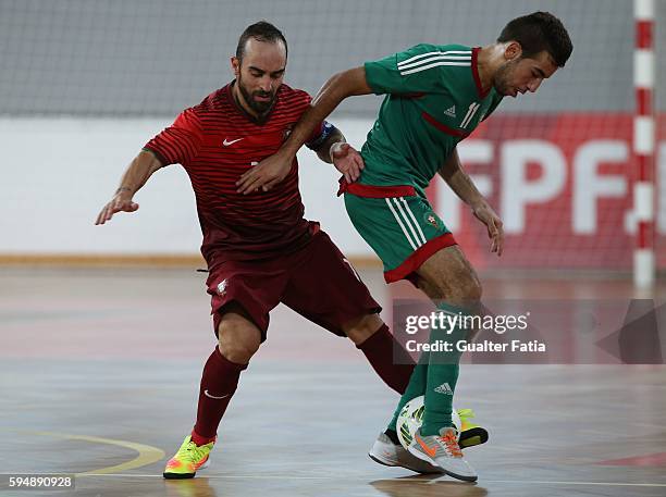 Morocco's Bilal Bakkali with Portugal's Ricardinho in action during the Futsal International Friendly match between Portugal and Morocco at Pavilhao...