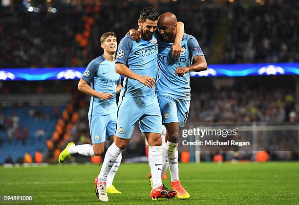 Fabian Delph of Manchester City celebrates scoring the opening goal with Nolito during the UEFA Champions League Play-off Second Leg match between...