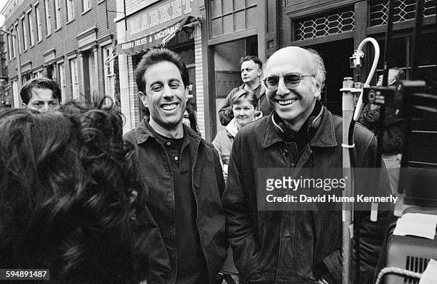Co-creators Jerry Seinfeld and Larry David laugh while talking with actress Julia Louis-Dreyfus on set of the hit television show "Seinfeld" during...
