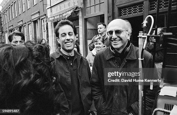 Co-creators Jerry Seinfeld and Larry David laugh while talking with actress Julia Louis-Dreyfus on set of the hit television show "Seinfeld" during...