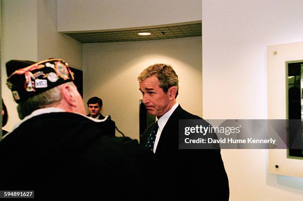 Presidential candidate, Texas Gov. George W. Bush , speaks to a veteran after the televised "The Republicans: A New Hampshire Forum" primary debate,...