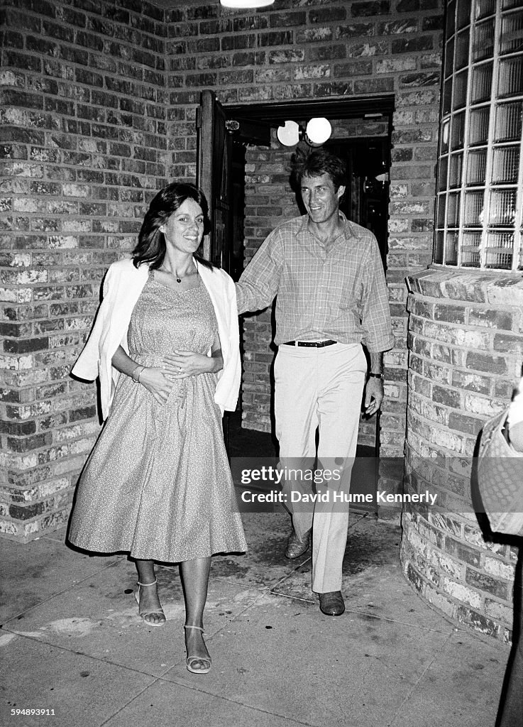 Actor John Perry with his wife Debbie Perry walk together