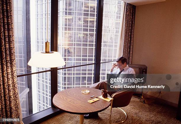 Former Secretary of Defense Donald Rumsfeld reads in his hotel room during the 1980 Republican National Convention, July 1980 in Detroit, Michigan. .