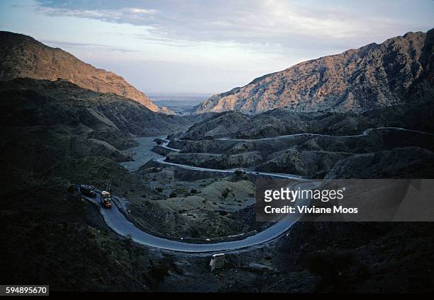 Trucks on the Khyber Pass road from Pakistan to the border of Afghanistan. | Location: Khyber valley Pass, NW Frontier, Pakistan.