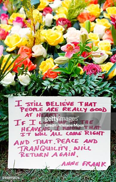 One day after the terrorist attack on the World Trade Center, a flower memorial to the missing and the victims with a written sign quoting Anne Frank...
