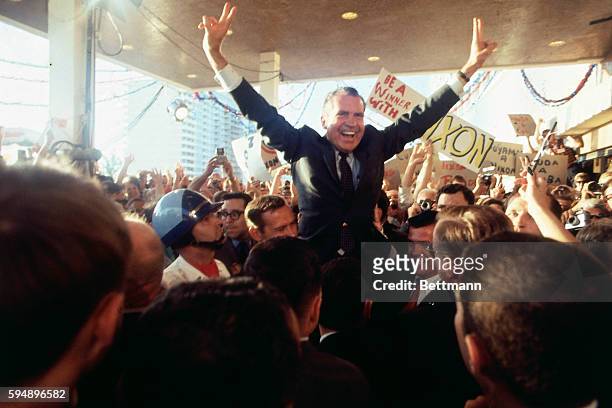 Richard M. Nixon is mobbed by wildly cheering supporters as he arrives at the Hilton Plaza Hotel, his Miami Beach headquarters.