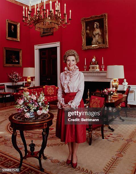 Official portrait of First Lady Nancy Reagan smiling in the White House, Washington DC, March 1981.