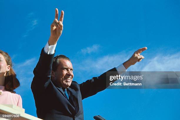 Richard Nixon gives his well-known two-armed victory salute during a campaign stop in El Paso.