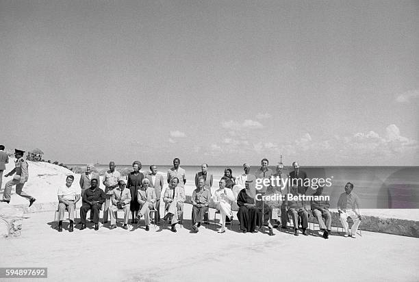 Cancun, Mexico: As a patrol boat sits off shore 23 world leaders gather on hotel patio for formal photograph at the North-South Economic Conference...
