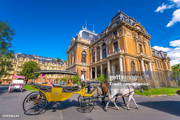 view of phaeton with historic building at karlovy vary - karlovy vary stock pictures, royalty-free photos & images