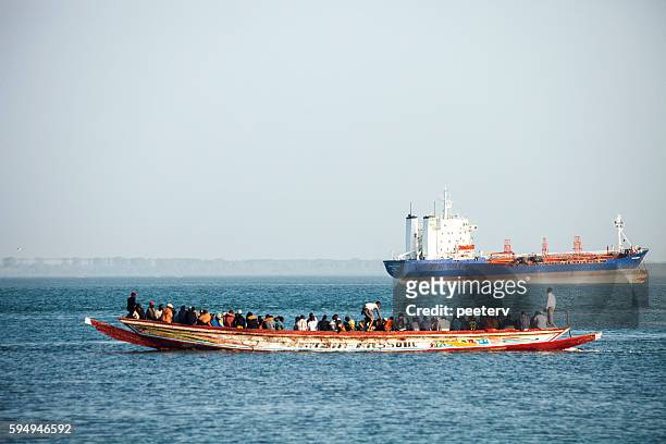boat overloaded with people. the gambia. - africa migration stock pictures, royalty-free photos & images
