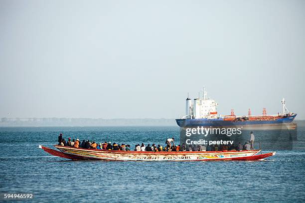 boat overloaded with people. the gambia. - gambia stock pictures, royalty-free photos & images
