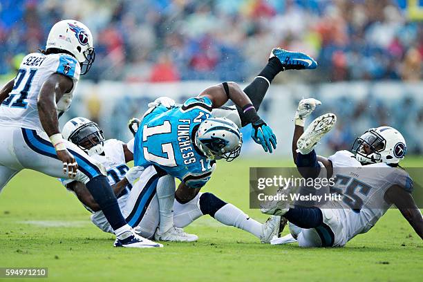 Devin Funchess of the Carolina Panthers is tacked by Brice McCain of the Tennessee Titans during a preseason game at Nissan Stadium on August 20,...