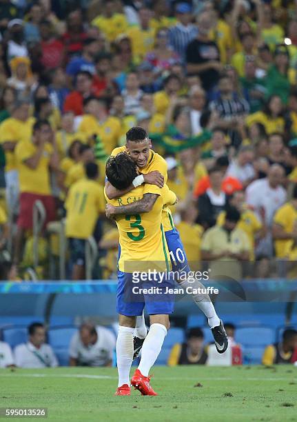 Neymar of Brazil celebrates scoring the first goal with Rodrigo Caio during the Men's Soccer Final between Brazil and Germany on day 15 of the Rio...