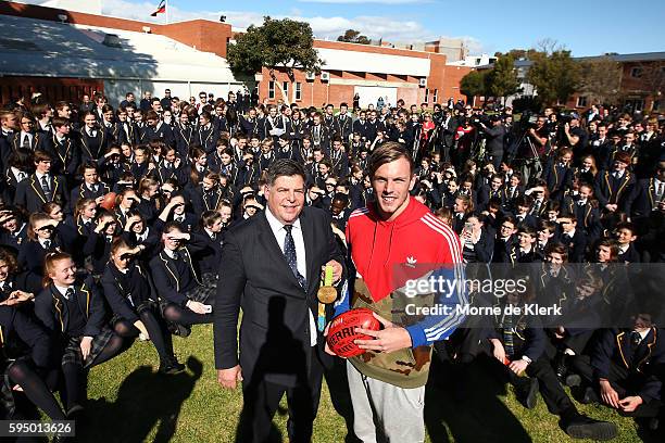 Australian Olympic Games gold medallist Kyle Chalmers shows his medal to students at Immanuel College on August 25, 2016 in Adelaide, Australia.