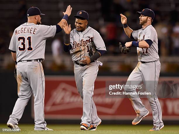 Casey McGehee, Erick Aybar and Andrew Romine of the Detroit Tigers celebrate winning the game against the Minnesota Twins on August 24, 2016 at...