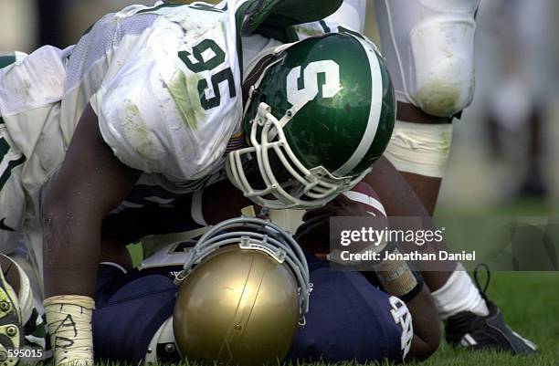 Defensive tackle Josh Shaw of Michigan State has a few words with quarterback Carlyle Holiday of Notre Dame after a sack in first half action at...