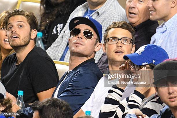 Zac Efron and Dylan Efron attend a baseball game between the San Francisco Giants and the Los Angeles Dodgers at Dodger Stadium on August 24, 2016 in...