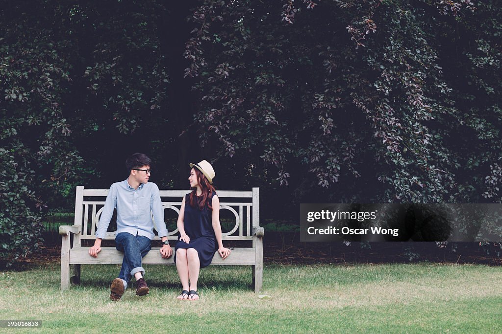 Young couple sitting on bench