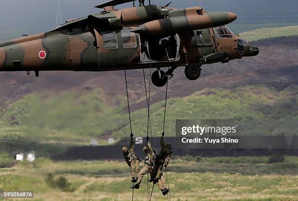 Japan Ground Self-Defence Force soldiers rappel down from UH-60 during the rehearsal for annual live firing exercise at the JGSDF's East Fuji...