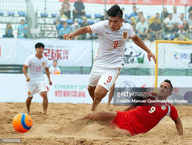 Bai Fan of China is tackled by Ali Nasserdine of Lebanon during the Continental Beach Soccer Tournament match between China and Lebanon at Municipal...