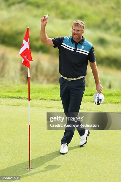 Robert Karlsson of Sweden celebrates a hole in one on the 16th hole during the first round of Made in Denmark at Himmerland Golf & Spa Resort on...