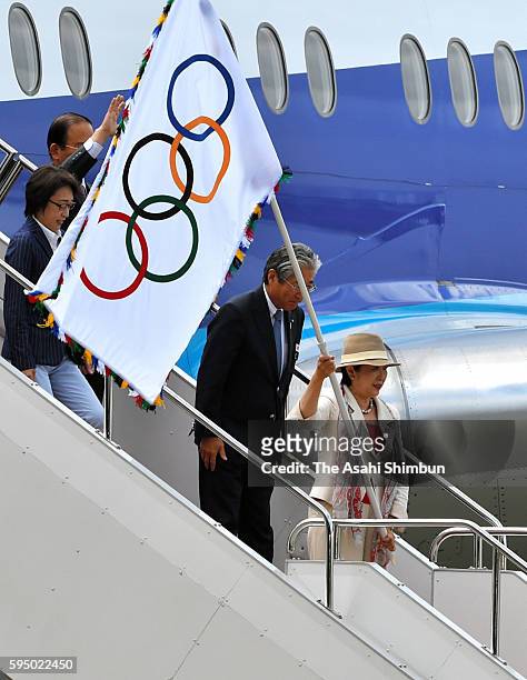 Tokyo Metropolitan Governor Yuriko Koike waves the Olympic flag on arrival at Haneda International Airport on August 24, 2016 in Tokyo, Japan.