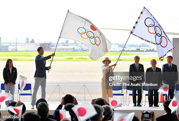 Tokyo Metropolitan Governor Yuriko Koike waves the Olympic flag while Keisuke Ushiro waves the Japanese Olympic flag during the ceremony at Haneda...