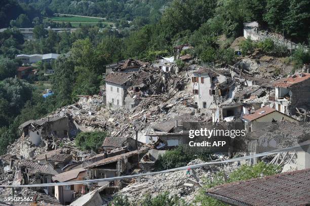 Damaged houses are pictured in Pescara del Tronto on August 25 a day after a 6.2-magnitude earthquake struck the region killing some 247 people. The...