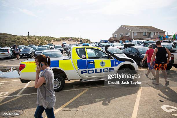 Police vehicle in the car park by Camber Sands on August 25, 2016 in Rye, England. Five men were found dead after being pulled from the sea on the...