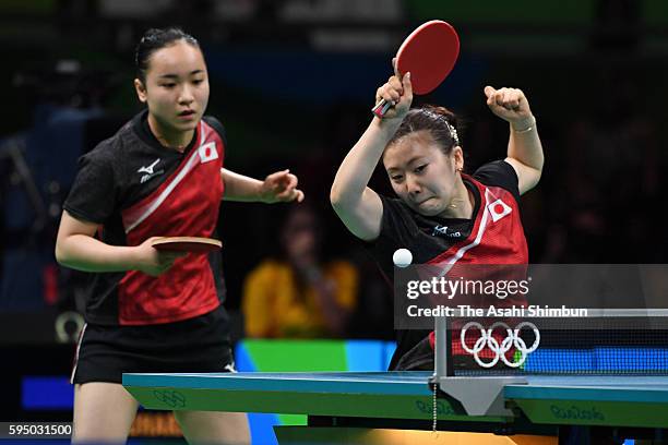 Ai Fukuhara and Mima Ito of Japan compete in a match against Mengyu Yu and Zhou Yihan of Singapore during the Women's Team Bronze Medal match on Day...