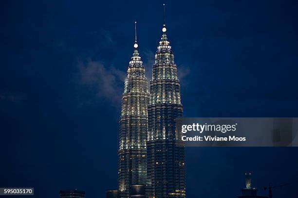 The Iconic Petronas Towers and the skybridge at night. The Petronas Twin Towers were the world's tallest buildings from 1998 to 2004, before being...