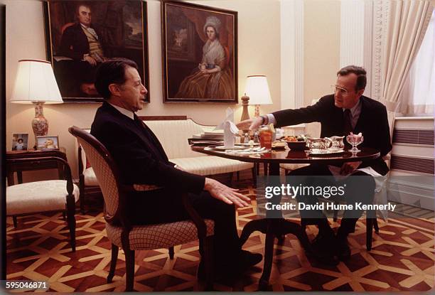 Secretary of Defense Caspar Weinberger dines with Vice President George H.W. Bush in the Old Executive Office Building circa 1983 in Washington, DC. .