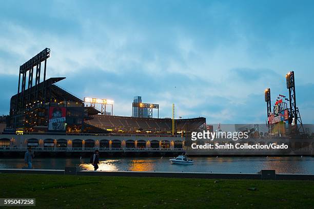 Park, home of the San Francisco Giants baseball team, illuminated at night after a home game, viewed from China Basin Park across McCovey Cove, San...
