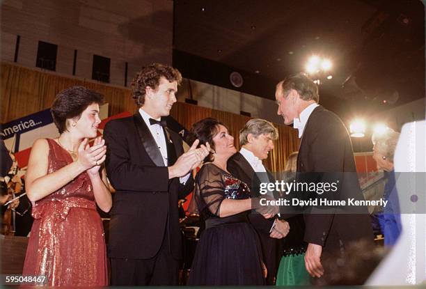 Vice President George H.W. Bush shaking hands with actress Elizabeth Taylor at President Reagan's inaugural ball on January 20, 1981 in Washington,...