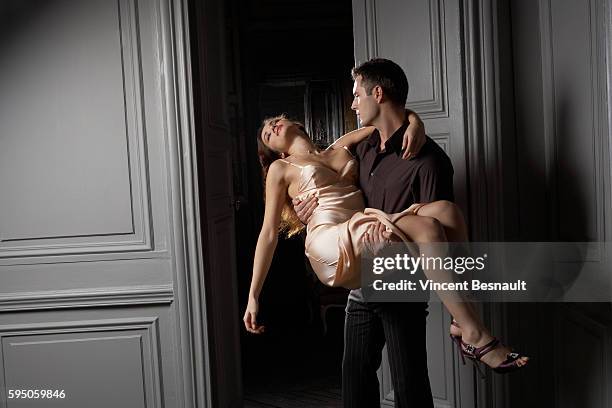 man carrying unconscious woman - unconscious stock pictures, royalty-free photos & images