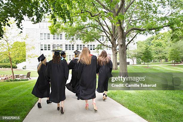 back view of college graduates walking away - university of missouri fotografías e imágenes de stock