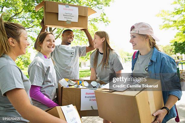 college students helping out in a food drive - food drive stock pictures, royalty-free photos & images