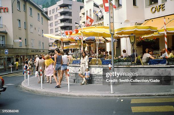 Female tourists poses outside Sternbrau restaurant in Salzburg, Austria, 1975. .