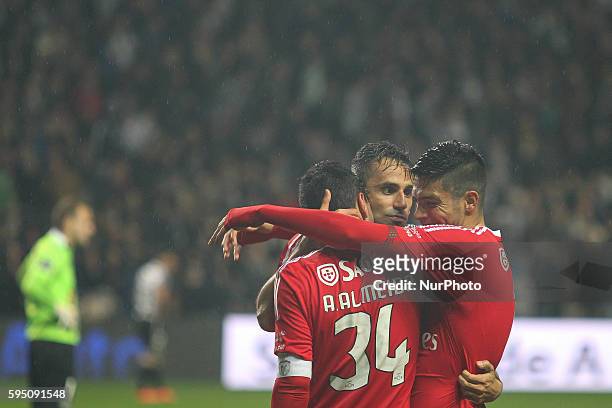 Benfica's Brazilian forward Jonas celebrates after scoring goal with teammates Benfica's Portuguese defender André Almeida and Benfica's Mexican...