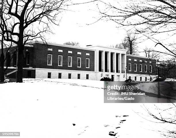 Looking northwest, the Milton S Eisenhower Library, its several levels extending underground, stands at the top of the grassy hill at the front of...