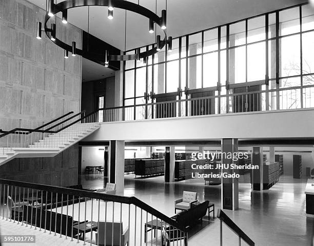 The inside of Milton S Eisenhower Library at its original design, including the open foyer and stairway between Q Level and M Level, with seating in...