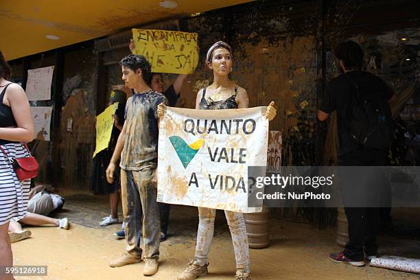 Rio de Janeiro, RJ, Brazil, November 16th 2015: Protesters group protest in downtown Rio against Vale, a company that is a partner of Samarco, along...