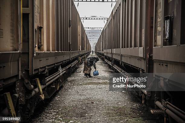 Woman between two trains at a makeshift camp at the Greek-Macedonian border, near the Greek village of Idomeni, on March 16 where thousands of...